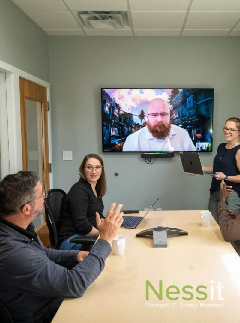 Visual representation of a user receiving support from an IT Helpdesk technician in a modern office setting.